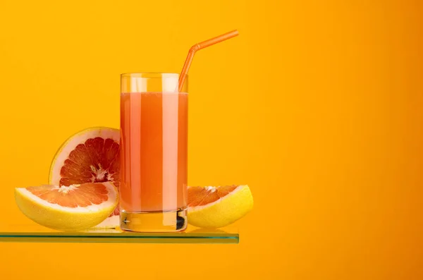 Glas frischer Grapefruitsaft mit frischen Früchten. — Stockfoto