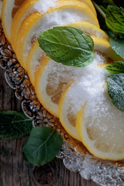 Lemon slices with sugar and mint leaves. — Stock Photo, Image