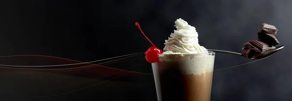 Layered coffee cocktail with whipped cream, cherry and pieces of — Stock Photo, Image