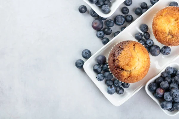 Muffins e mirtilo na mesa branca . — Fotografia de Stock