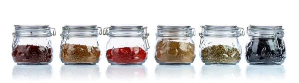 Various Oriental spices and herbs in glass jars. — Stock Photo, Image