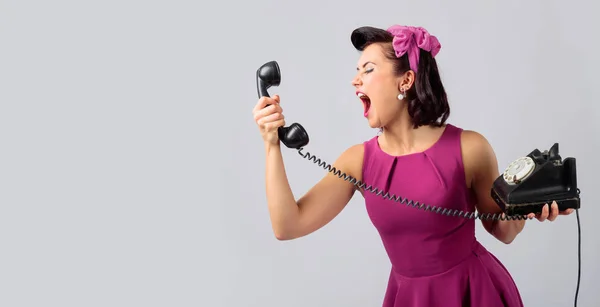 Beautiful woman in purple dress with vintage black phone. — Stock Photo, Image