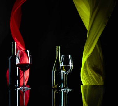 Red and white wine on a black reflective background.  clipart