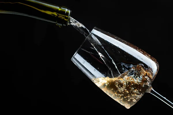 White wine being poured into wine glass. — Stock Photo, Image