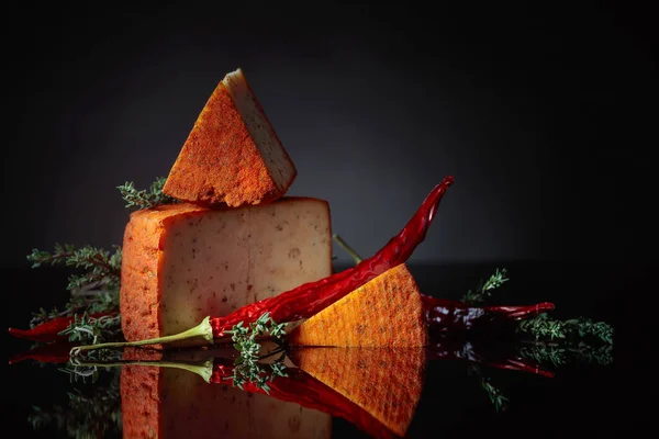 Red Pecorino sheep milk cheese with thyme and red pepper. — Stock Photo, Image