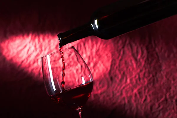 Bottle and glass of red wine on a dark  background — Stock Photo, Image