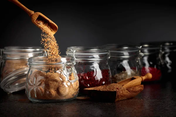 Various Oriental spices and herbs in glass jars. — Stock Photo, Image