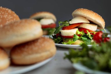 Mozzarella peyniri, domates, salata mutfak masasında ile sandviç.