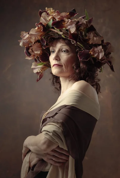 Attractive woman in wreath with brown iris blossoms. — Stock Photo, Image