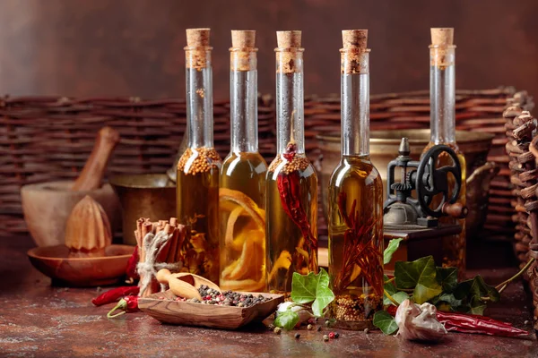 Bottles of olive oil with various spices and vintage cooking ute — Stock Photo, Image