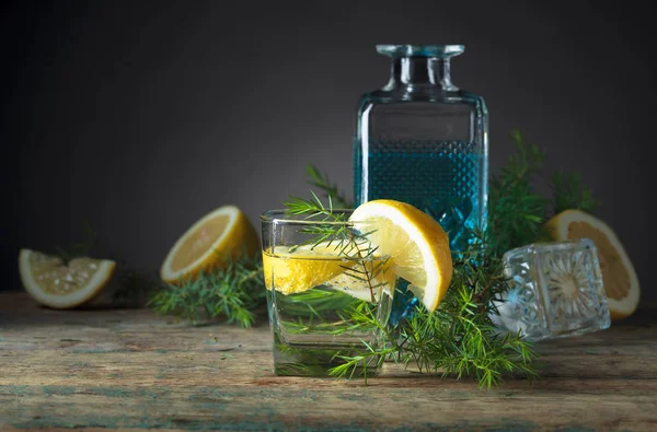 Cocktail with blue gin , tonic and lemon on a old wooden table . — Stock Photo, Image