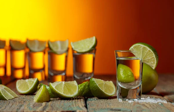 Tequila med salt och lime på en gammal träbakgrund. — Stockfoto