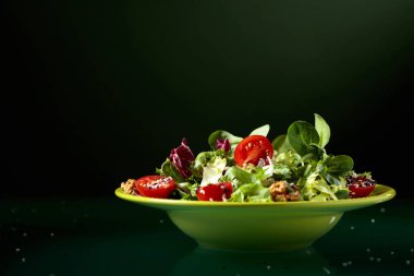 Kiraz domates, ceviz ve susam ile yeşil salata.