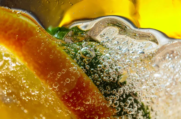 Carbonated drink or cocktail with lemon, abstract splashing.