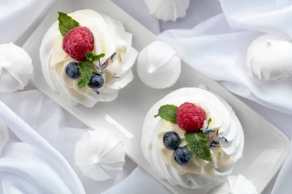 Dessert Pavlova med hindbær, blåbær og mynte på en whit - Stock-foto