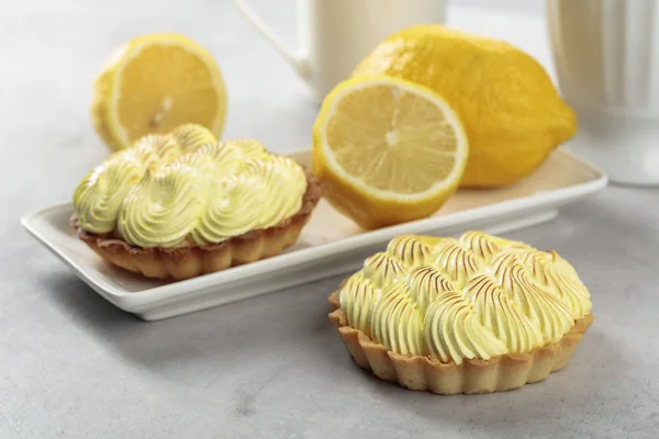 Tartlets with lemon cream on a white table.