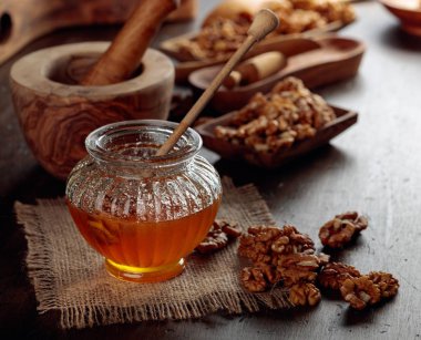 Eski ahşap masada bal ve ceviz.