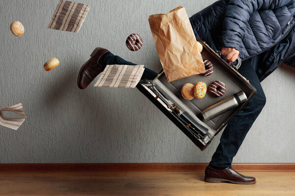 The man runs to the office: he is late and loses the contents of