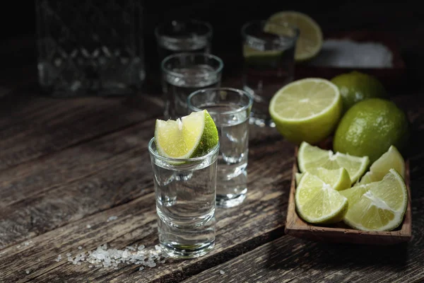 Tequila with  salt and lime on a old wooden background. — Stock Photo, Image