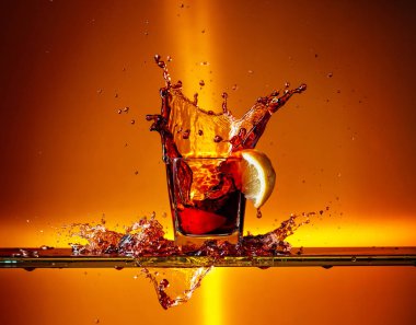 Bir bardak Kolanın içine düşen limon dilimi. 