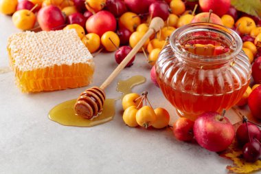 Red and yellow crab apples with honey, healthy organic food. clipart