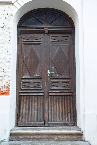 조각된 장신구가 있는 오래 된 나무로 된 문. — 스톡 사진