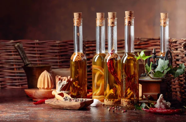 Bottles of olive oil with various spices and vintage cooking ute — Stock Photo, Image