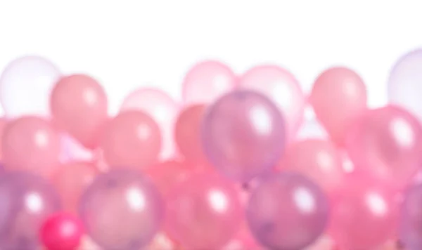 Defocused pink and purple balloons isolated on  white.