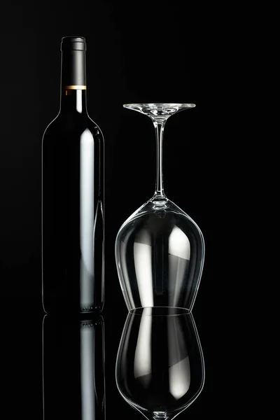 Bottle Red Wine Inverted Wine Glass Black Background Concept Winemaking — Stock Photo, Image