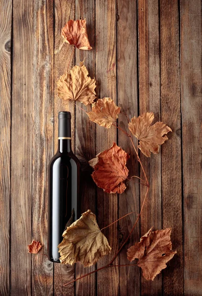 Eine Flasche Rotwein Mit Vertrockneten Weinblättern Alter Holzuntergrund Kopierraum Ansicht — Stockfoto