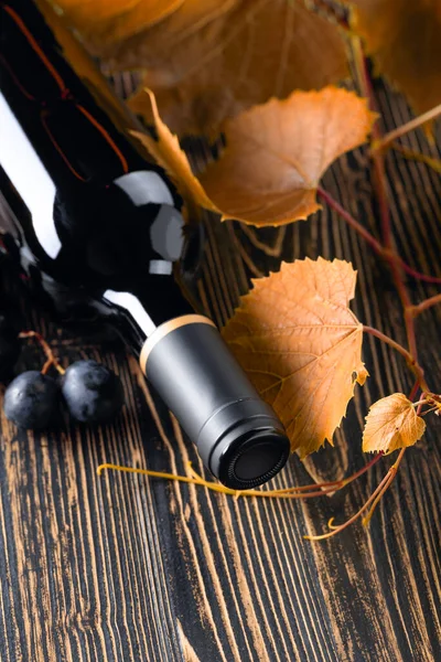 Ungeöffnete Rotweinflasche Weinzweig Und Trauben Auf Einem Alten Holztisch Kopierraum — Stockfoto