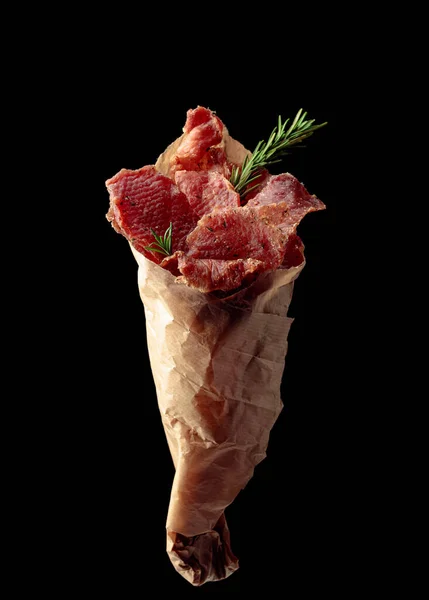 Slices Spicy Dry Cured Meat Rosemary Paper Bag Isolated Black — Stock Photo, Image