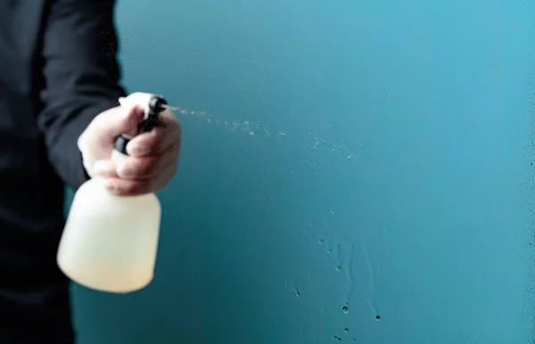 ゴム手袋の男はガラスに消毒剤を噴霧します 選択的な焦点 スペースのコピー — ストック写真