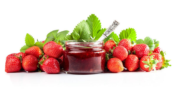 Strawberry jam in a small jar and fresh berries with leaves isolated on a white background.
