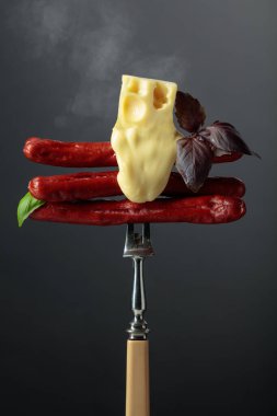 Erimiş peynir ve fesleğenli ızgara ince sosis..