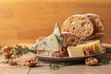 Mutfak masasında peynir, ekmek, ceviz ve kekik. Boşluğu kopyala.