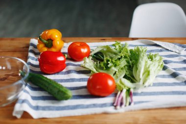 Taze sebze: domates, yeşil salatalık kırmızı Bulgar biber ahşap mutfak masasında hazır salata yapmak için.