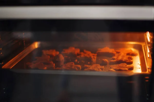 Baking pan with cookies in the oven during baking