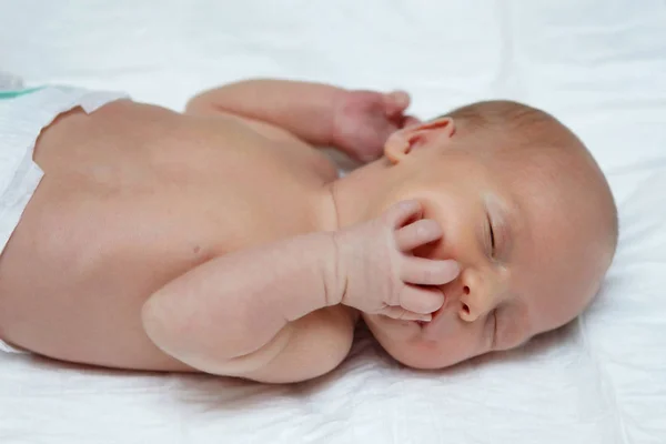 Bebé Desnudo Yace Boca Arriba Sobre Una Sábana Blanca Muestra —  Fotos de Stock