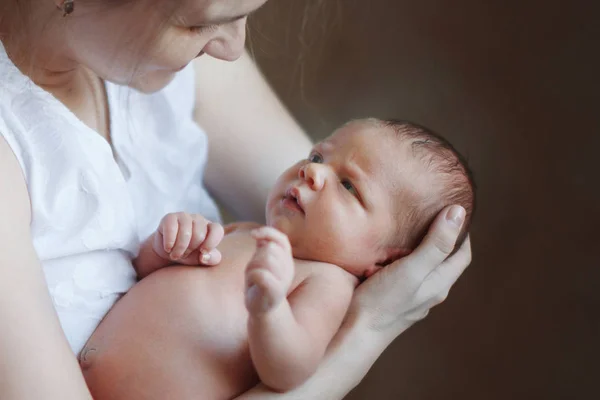 Young Cute Mother Holds Her Arms Looks Sleeping Newborn Son — Stock Photo, Image