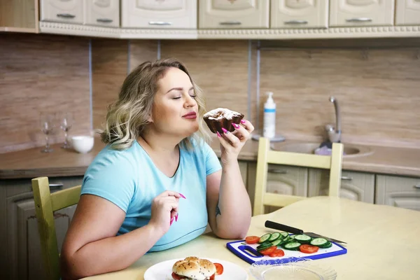 Fat woman feeling guilty while eating junk food