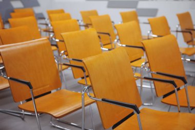 Konferans odasındaki sarı sandalye satırı. Kamu konuşma için alan.