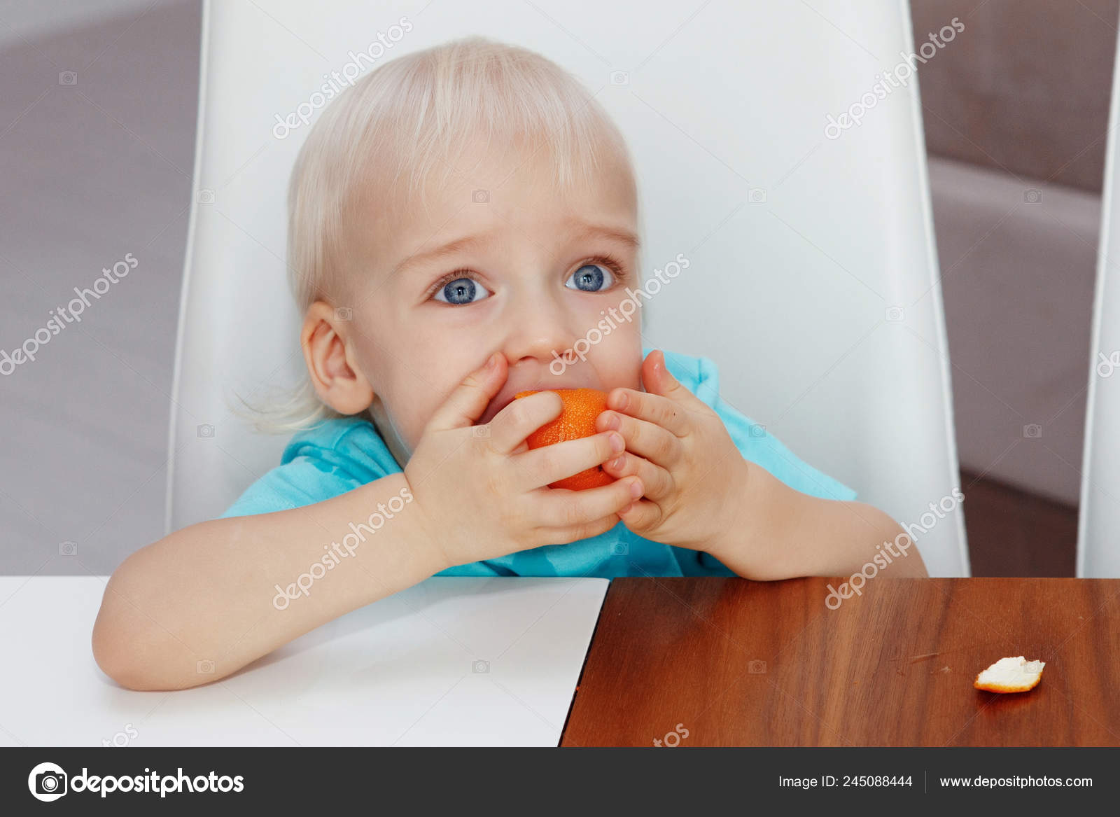 Cute Boy Blond Hair Blue Eyes Eating Orange Selective Focus