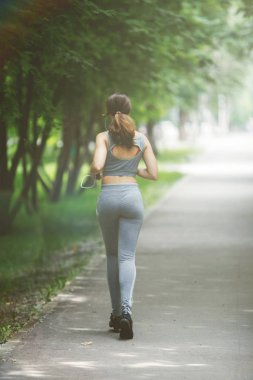 Genç kadın yeşil park yolda koşu