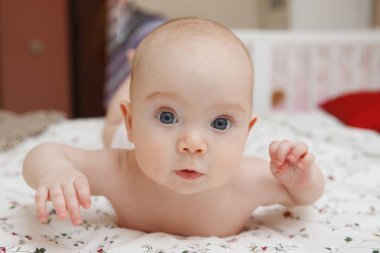 Midesini yüzünde çeşitli duygular yatan güzel beş aylık mavi gözlü bebek kız bebek. Bebek bak. Anne bakım. Çocuk Bakımı. Yakın çekim.