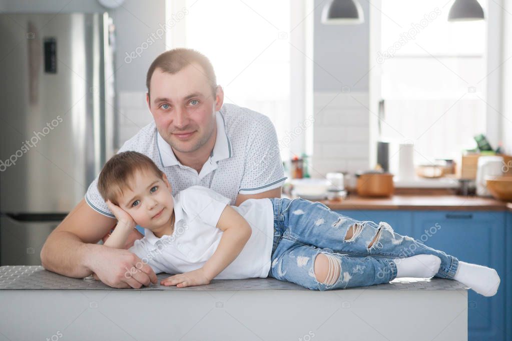 Father and son are smiling while spending time together. Little 
