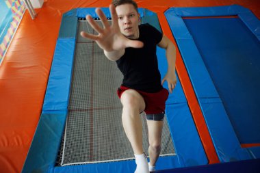 Bir trambolin üzerinde atlama genç adam.