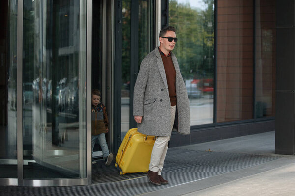 Man with a yellow suitcase.