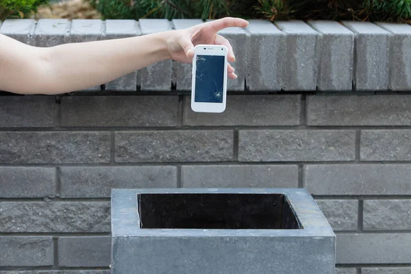 Hand above a garbage.