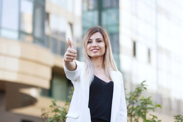 Two woman shows thumb up